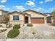 Charming single-story home featuring desert landscaping, a covered entry, and a two-car garage at 138 Scarlett View Ave, North Las Vegas, NV 89031
