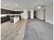 Kitchen and Living area featuring stainless appliances and island on the tile, flowing to carpeted living space at 138 Scarlett View Ave, North Las Vegas, NV 89031