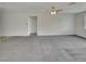 Open living room with neutral carpeting, bright windows and ceiling fan at 138 Scarlett View Ave, North Las Vegas, NV 89031