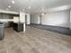 Open-concept living area featuring tile flooring, gray carpet, recessed lighting, and neutral wall paint throughout at 138 Scarlett View Ave, North Las Vegas, NV 89031