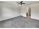 Neutral main bedroom with gray carpet, ceiling fan, and a walk-in closet for optimal comfort at 138 Scarlett View Ave, North Las Vegas, NV 89031