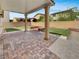 Covered patio featuring brick flooring and outdoor seating area, offering an ideal spot for relaxation and entertaining at 138 Scarlett View Ave, North Las Vegas, NV 89031