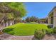 Enjoy the manicured lawn, sparkling pool, and covered patio with this backyard at 1508 Ten Palms Ct, Las Vegas, NV 89117