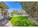 The backyard features a pool, artificial turf, and an outdoor kitchen at 1508 Ten Palms Ct, Las Vegas, NV 89117