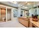 Bright bathroom with a spacious vanity, walk-in shower, and ample natural light from the window and skylight at 1508 Ten Palms Ct, Las Vegas, NV 89117