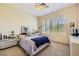 Comfortable bedroom with ceiling fan, neutral carpet, and ample natural light at 1508 Ten Palms Ct, Las Vegas, NV 89117
