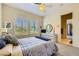 Cozy bedroom with plantation shutters, ceiling fan, and ensuite bathroom at 1508 Ten Palms Ct, Las Vegas, NV 89117