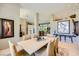 Open dining room with a marble table, neutral chairs, and an open floor plan at 1508 Ten Palms Ct, Las Vegas, NV 89117