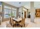 Elegant dining room featuring a marble-top table, neutral decor, and plenty of natural light at 1508 Ten Palms Ct, Las Vegas, NV 89117