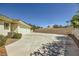 Spacious concrete driveway with a two-car garage and beautiful brick perimeter walls at 1508 Ten Palms Ct, Las Vegas, NV 89117