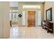 Inviting foyer with tile flooring, natural wood door, and ample natural light at 1508 Ten Palms Ct, Las Vegas, NV 89117