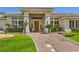 Charming front entrance with a beautiful wooden door and meticulously maintained landscaping at 1508 Ten Palms Ct, Las Vegas, NV 89117