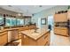 Spacious kitchen boasts an island, stainless appliances, granite counters, and ample cabinet storage at 1508 Ten Palms Ct, Las Vegas, NV 89117