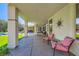 The covered patio includes several seating areas, ideal for relaxing and enjoying the backyard view at 1508 Ten Palms Ct, Las Vegas, NV 89117