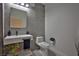 Modern bathroom with gray tiled walls, floating sink, and stylish fixtures at 1830 N Buffalo Dr # 1091, Las Vegas, NV 89128