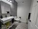 Modern bathroom featuring a floating vanity with a sleek black faucet and a gray tile accent wall at 1830 N Buffalo Dr # 1091, Las Vegas, NV 89128