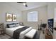 Bright bedroom with a ceiling fan, a large window, and a comfortable king-size bed with stylish decor at 1830 N Buffalo Dr # 1091, Las Vegas, NV 89128