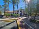 Inviting clubhouse entrance with desert landscaping and palm trees for a welcoming community vibe at 1830 N Buffalo Dr # 1091, Las Vegas, NV 89128