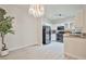 View of the kitchen with black appliances and modern light fixtures, open to the living room at 1830 N Buffalo Dr # 1091, Las Vegas, NV 89128