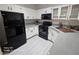 Spacious kitchen featuring white cabinets, black appliances, and gray countertops at 1830 N Buffalo Dr # 1091, Las Vegas, NV 89128