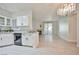 Open-concept living area with fireplace, modern lighting, and sliding glass doors to patio at 1830 N Buffalo Dr # 1091, Las Vegas, NV 89128