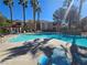 Resort-style pool with lounge chairs and palm trees, perfect for relaxation and outdoor enjoyment at 1830 N Buffalo Dr # 1091, Las Vegas, NV 89128