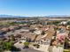 Residential homes with red tile roofs in community near shopping and distant mountains at 1890 Bova Matrina Ct, Las Vegas, NV 89123