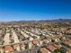 An aerial view of a desert community showcases mountain views and the community's layout at 1890 Bova Matrina Ct, Las Vegas, NV 89123