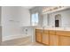 Primary bathroom featuring bathtub and double sink vanity with wood cabinets at 1890 Bova Matrina Ct, Las Vegas, NV 89123