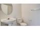 A white pedestal sink and toilet are featured in this half bathroom at 1890 Bova Matrina Ct, Las Vegas, NV 89123