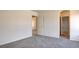 An open bedroom with neutral gray carpet adjoins an ensuite bathroom and second bedroom at 1890 Bova Matrina Ct, Las Vegas, NV 89123