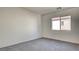 Light filled bedroom with gray carpet and window overlooking exterior at 1890 Bova Matrina Ct, Las Vegas, NV 89123