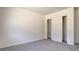 Carpeted bedroom featuring a built-in closet with white sliding doors at 1890 Bova Matrina Ct, Las Vegas, NV 89123