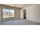 Bright bedroom with neutral walls, carpet flooring, and a window with neighborhood views at 1890 Bova Matrina Ct, Las Vegas, NV 89123