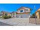 Two story home features stucco facade, tile roof, three-car garage and mature landscaping at 1890 Bova Matrina Ct, Las Vegas, NV 89123