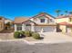 Two story home features stucco facade, tile roof, three-car garage and mature landscaping at 1890 Bova Matrina Ct, Las Vegas, NV 89123