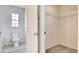 Hallway showcasing a bathroom with a toilet and an open closet with shelving at 1890 Bova Matrina Ct, Las Vegas, NV 89123