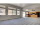 Large living room area with bright natural light, plush carpeting, and an open layout at 1890 Bova Matrina Ct, Las Vegas, NV 89123
