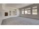Open living area features a fireplace, built-in shelving, plush carpeting, and natural light at 1890 Bova Matrina Ct, Las Vegas, NV 89123