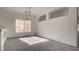 Sunlit room with plush gray carpet and a large window offering a bright, inviting space at 1890 Bova Matrina Ct, Las Vegas, NV 89123