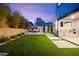 Beautiful backyard featuring an outdoor kitchen, patio area, and well-maintained artificial grass at 2407 Ridgeline Wash St, Las Vegas, NV 89138