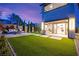 Serene backyard with artificial turf, outdoor kitchen, and covered patio at 2407 Ridgeline Wash St, Las Vegas, NV 89138