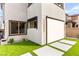 A spacious backyard featuring easy-care artificial turf and shade-enhancing screens, offering serene outdoor space at 2407 Ridgeline Wash St, Las Vegas, NV 89138