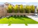 The backyard features lush artificial grass, with privacy landscaping, and outdoor seating at 2407 Ridgeline Wash St, Las Vegas, NV 89138