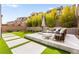 Beautiful backyard oasis with stylish outdoor seating and lush landscaping at 2407 Ridgeline Wash St, Las Vegas, NV 89138