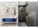 Bright bathroom showcasing a modern floating vanity, large mirrors, and luxurious glass shower at 2407 Ridgeline Wash St, Las Vegas, NV 89138
