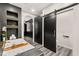 Bathroom featuring a soaking tub, black accent wall with gold trim and a sliding barn door at 2407 Ridgeline Wash St, Las Vegas, NV 89138