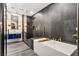 Sleek bathroom with a soaking tub, a glass-enclosed shower, and modern fixtures in contrasting styles at 2407 Ridgeline Wash St, Las Vegas, NV 89138