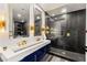 Sleek bathroom with double sinks, gold fixtures, and glass shower at 2407 Ridgeline Wash St, Las Vegas, NV 89138