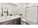 Well-lit bathroom featuring double sinks, a shower-tub combination, and modern fixtures at 2407 Ridgeline Wash St, Las Vegas, NV 89138